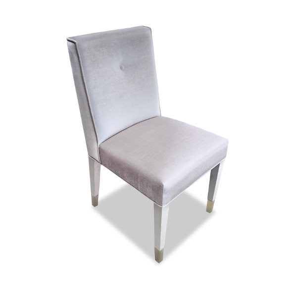 A fully upholstered dining chair with elegant upholstered legs and real brass slipper cups. The Seward is an excellent choice to bring a lot of fabric into the room.